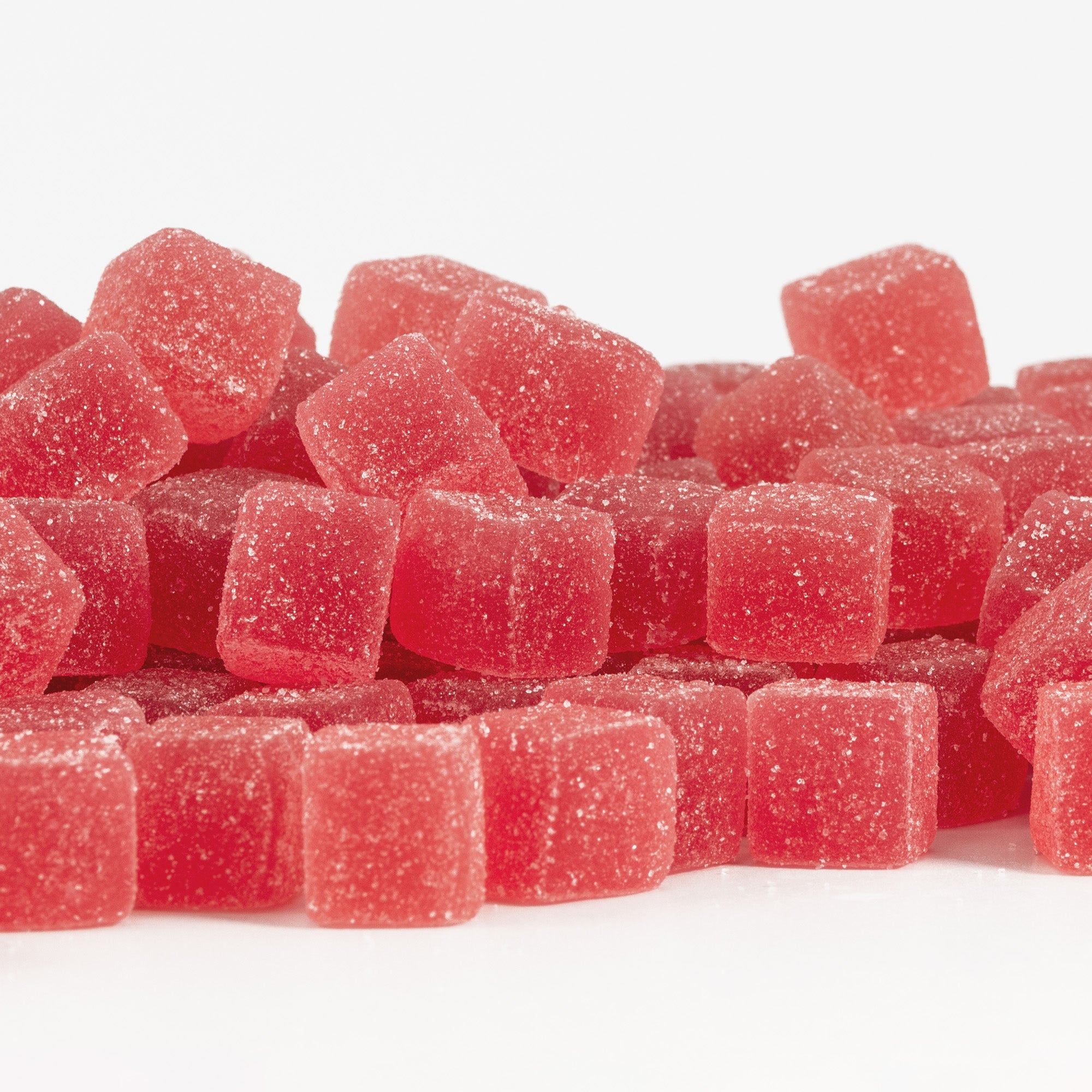 Strawberry Pomelo gummy cubes on a white background